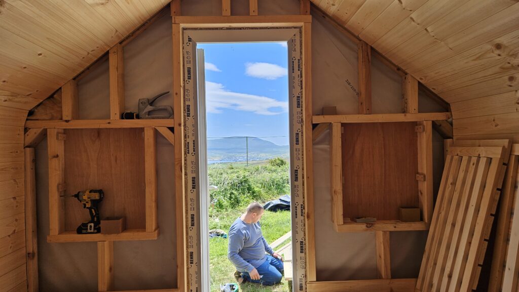 Bee Bed cabin under construction with observation hive wall being built.